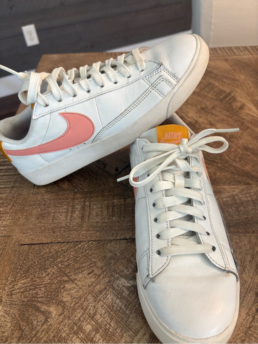 Nike White Leather Low-Top Sneakers with Pink Swoosh and Yellow Heel Tab